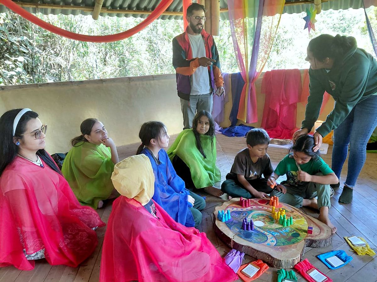 Mothers in colored veils and kids around the board