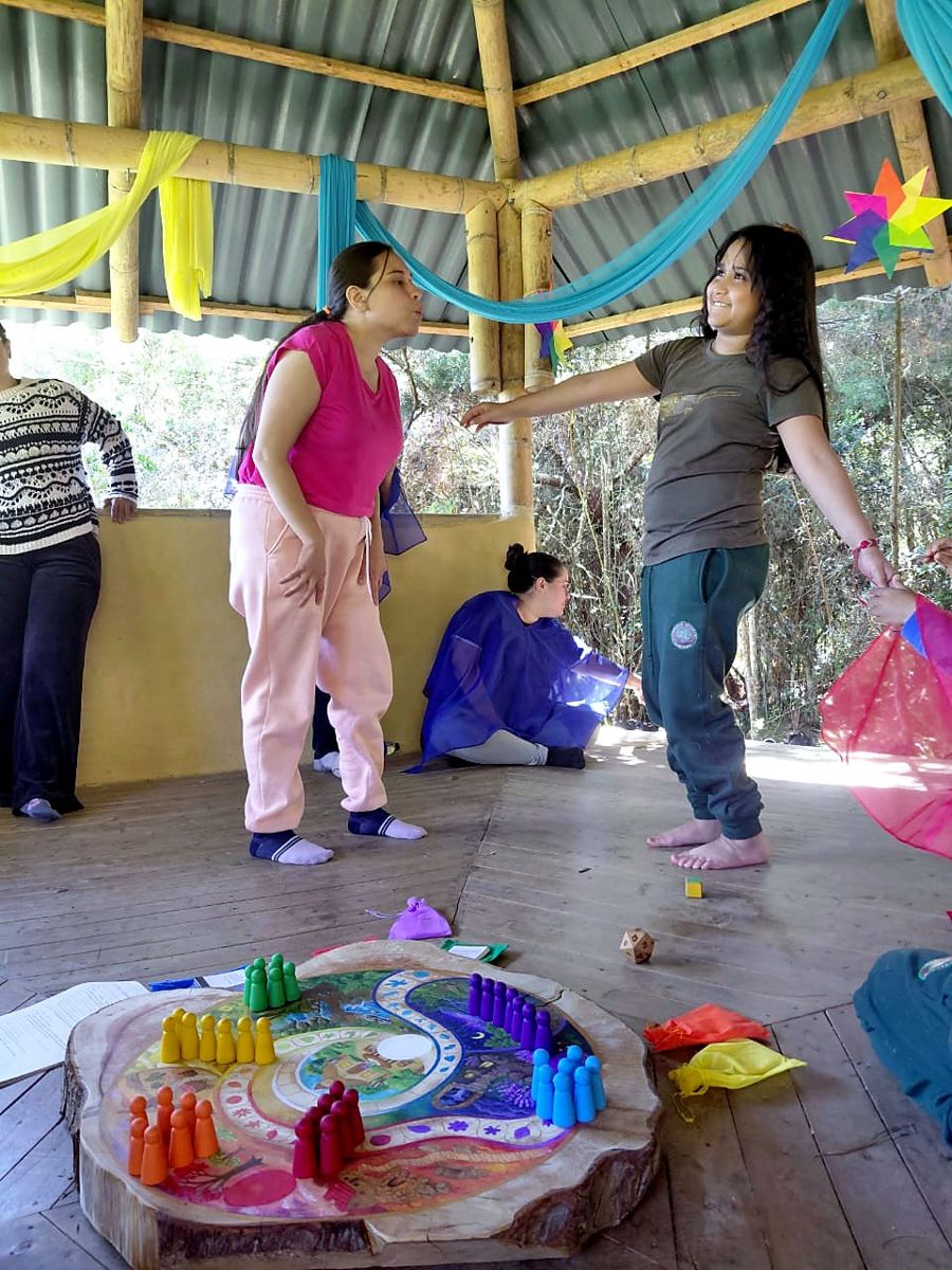 Two participants taking on a movement challenge next to the board